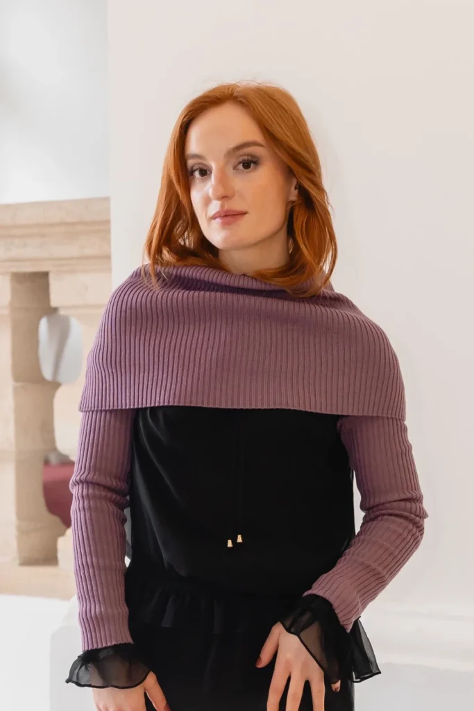 Spring outfit idea with purple knit accessories styled over a black dress