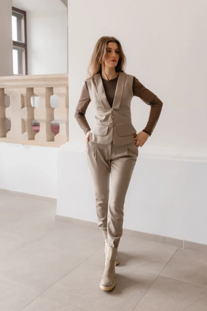 Beige neutral outfit with tailored vest and pants styled as a base for knit accessories layering