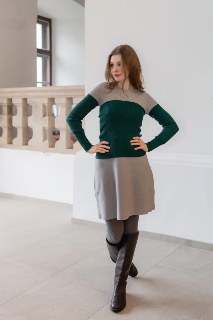 Neutral grey dress styled with green knit waist warmer and arm warmers, creating a fitted, structured and versatile layered outfit.