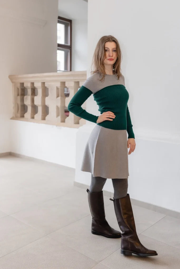 Grey dress styled with green knit top and arm warmers – minimalist layered outfit with knit accessories