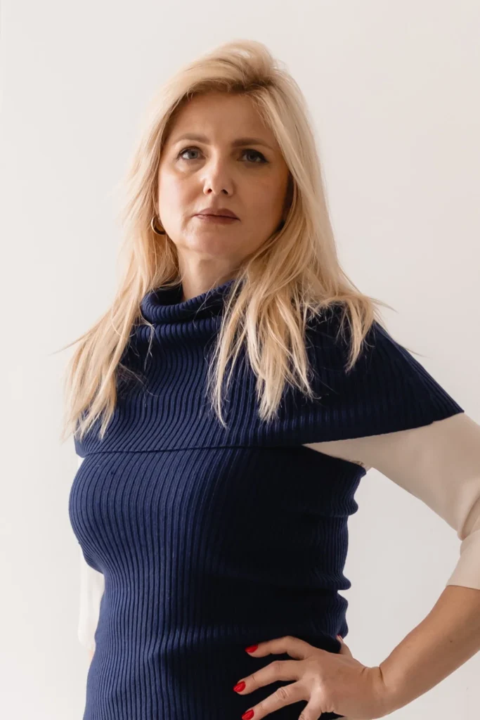 Close-up of navy knit neck warmer layered over a neutral outfit
